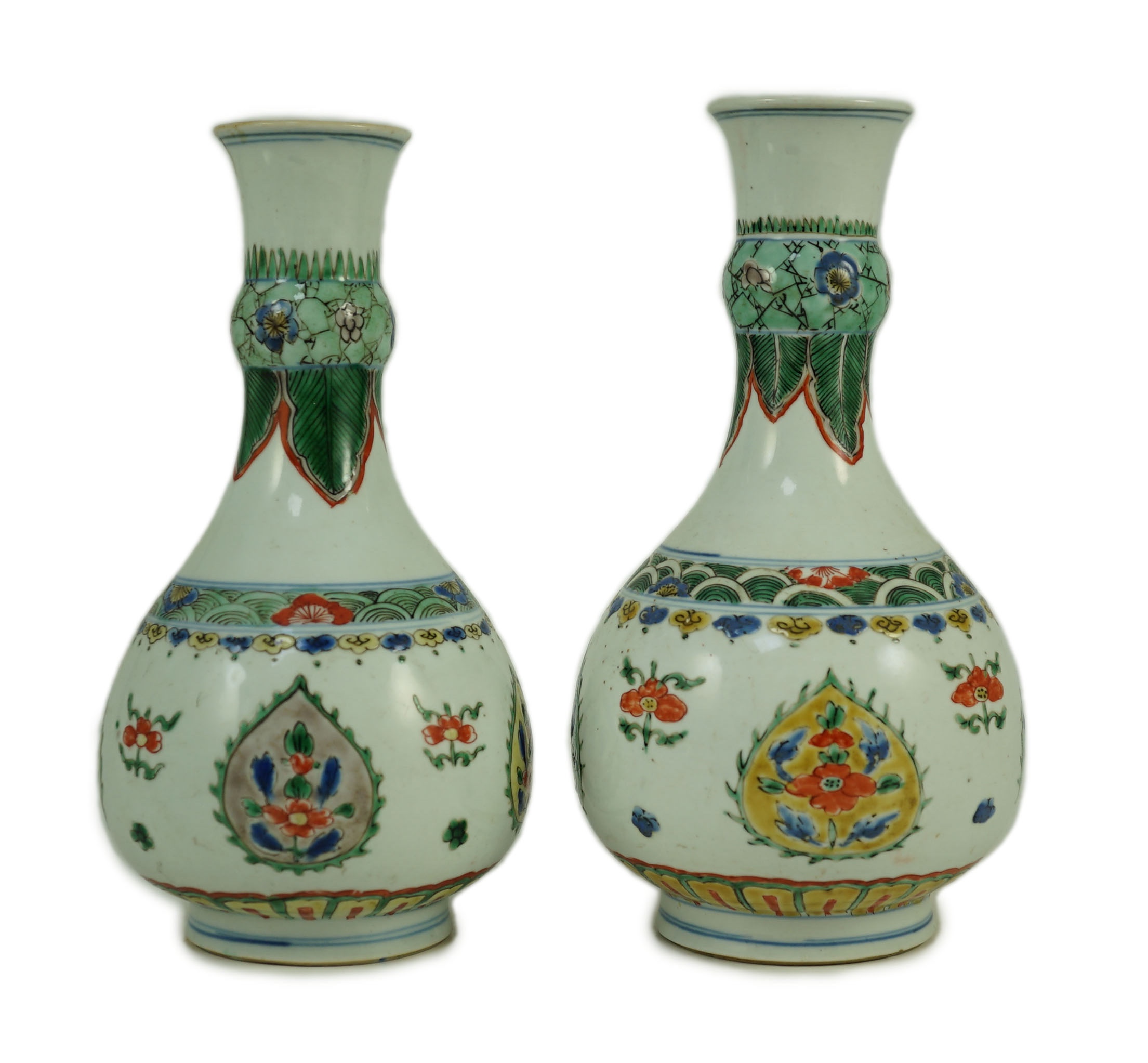 A near pair of Chinese famille verte garlic-neck vases, Kangxi period, 20cm and 20.5cm high, One vase restored